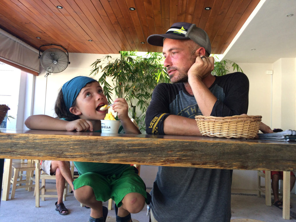 an old man watches his son eat some type of gelato while they discuss living in vans and RVs