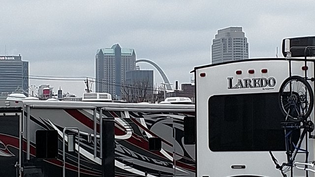 Class A RVs camping within view of the arch in St. Louis.