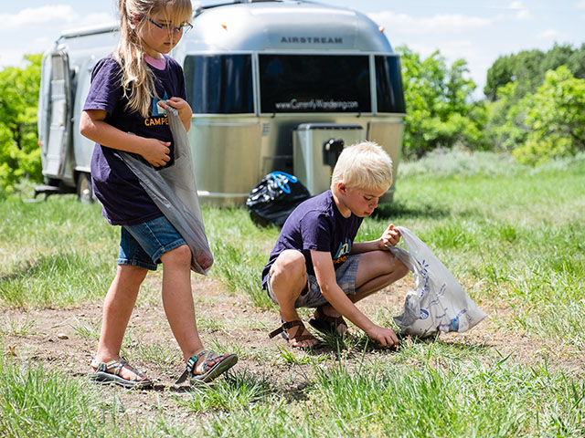 children cleaning their campsite