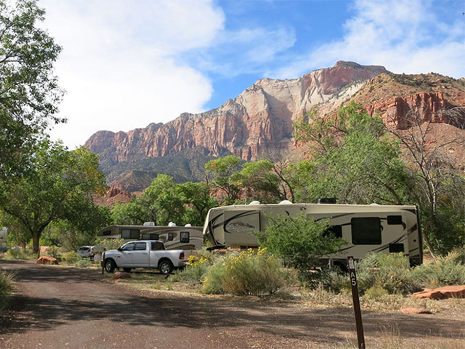 5th wheels and Class A RVs camping in the Southwestern united states, presumably on a roadtrip