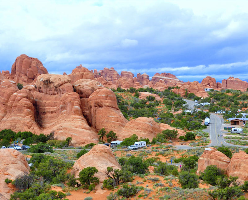 campers utilizing a campground in the orange and tan rock formations of Arches National Park