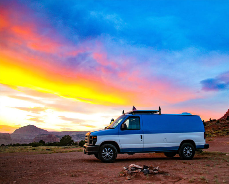 a van camping beneath the rainbow sunset of Capitol Reef national park