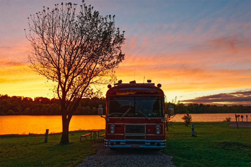 A bus camping at sunset in an Iowa state park