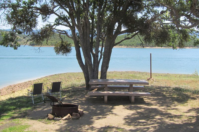 Two chairs and a picnic table by Emigrant Lake