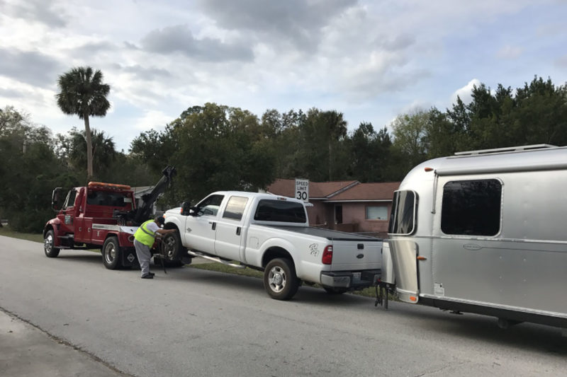 truck getting towed with an airstream
