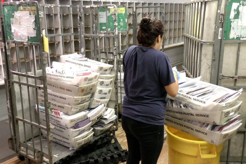 A woman sorting mail