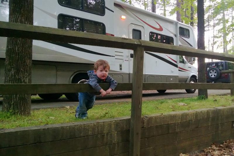 Young boy in front of an RV