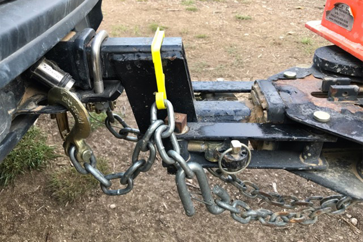 Chain attaching an RV to a trailer trailer.