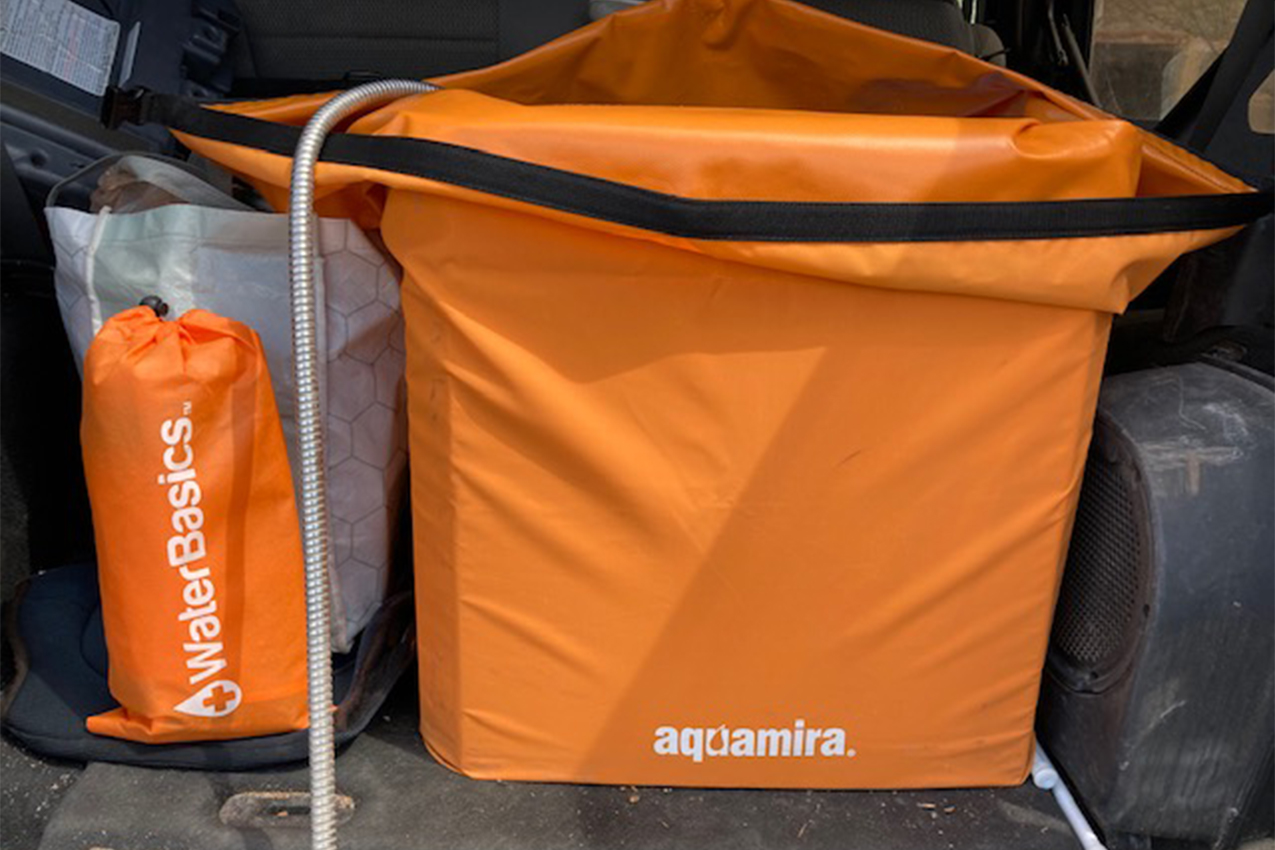 Orange square tote in the back of a truck.