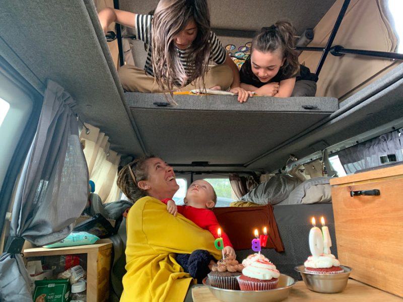 a mom and three of her children having a birthday celebration in their van
