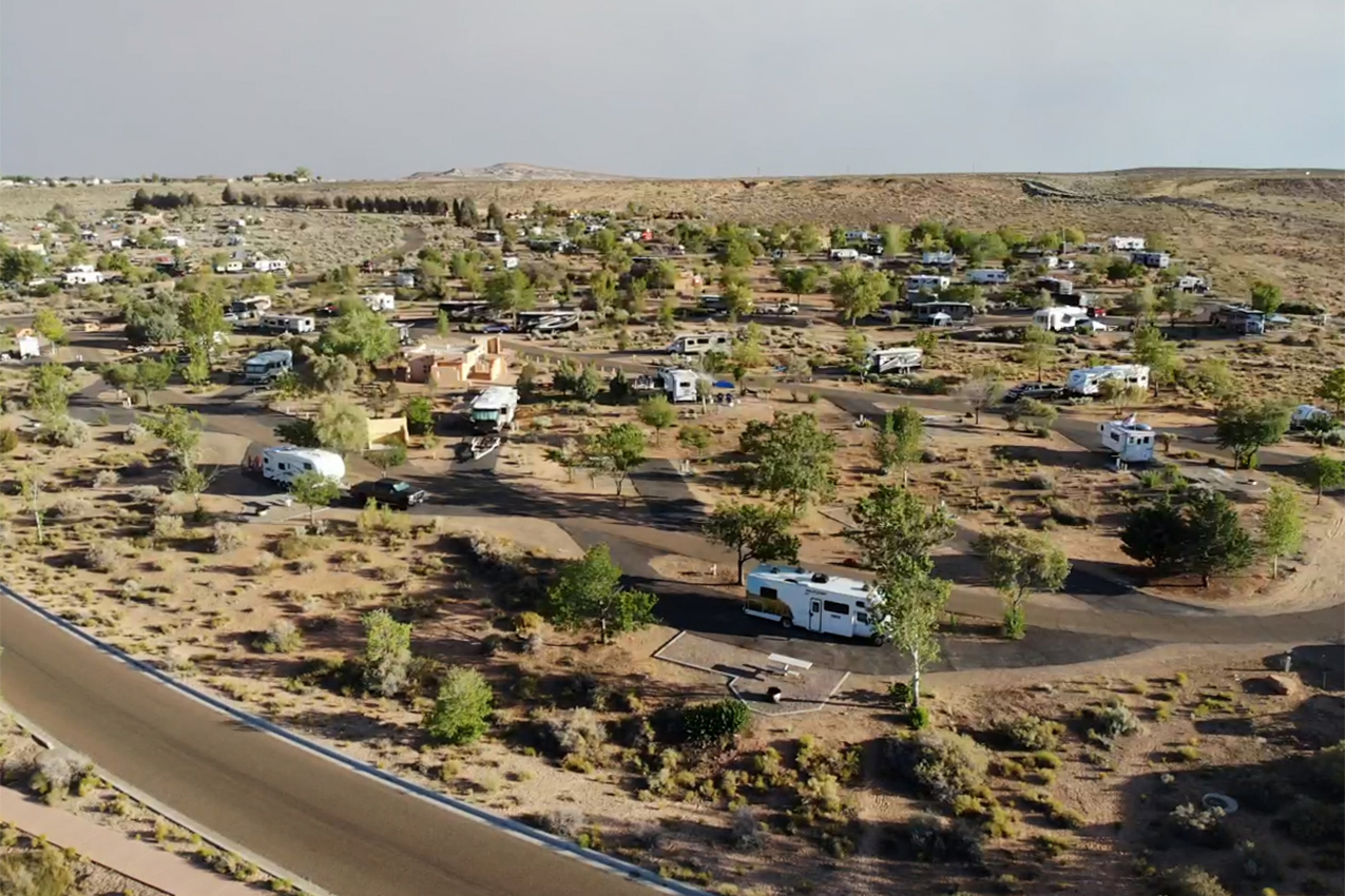 RV park in the desert filled with rigs.