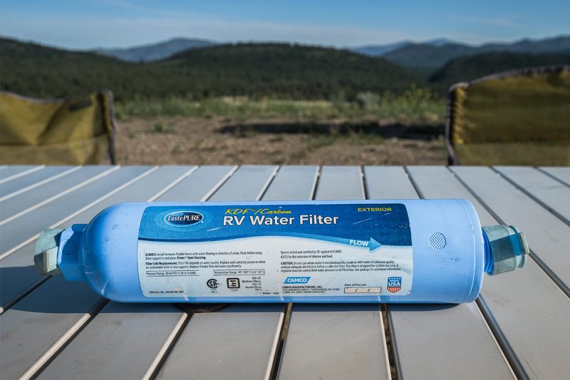 RV carbon water filter on a picnic table.