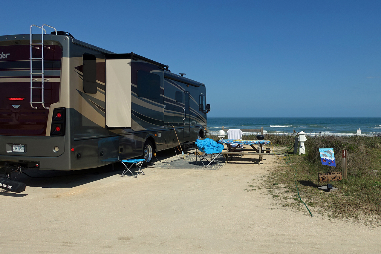 Class A parked on the beach with an ocean view.