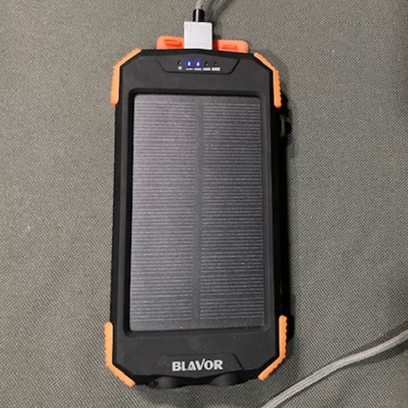 Solar power battery bank laying on the bed.
