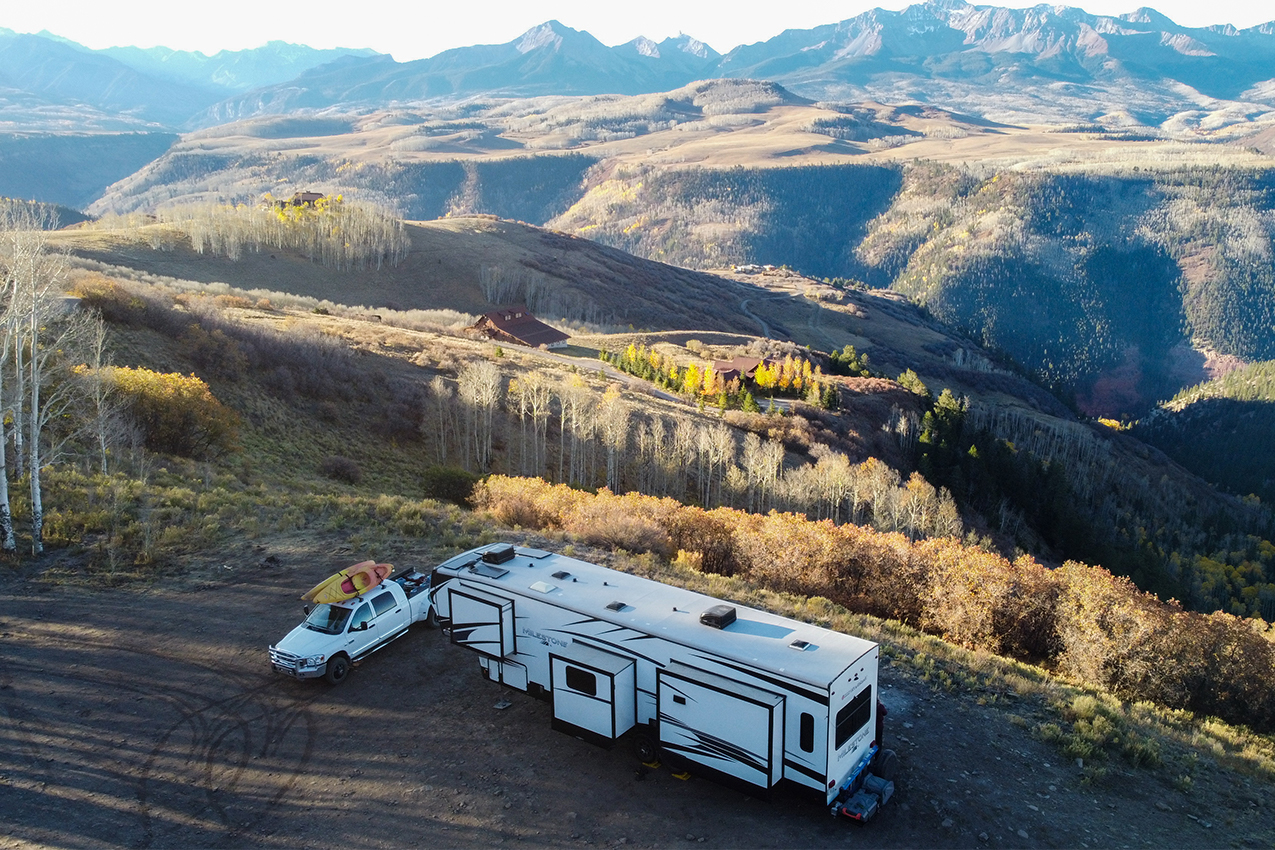 Aerial shot of RV and mountains.