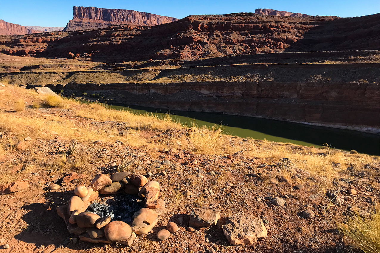 Fire pit above river and canyon.