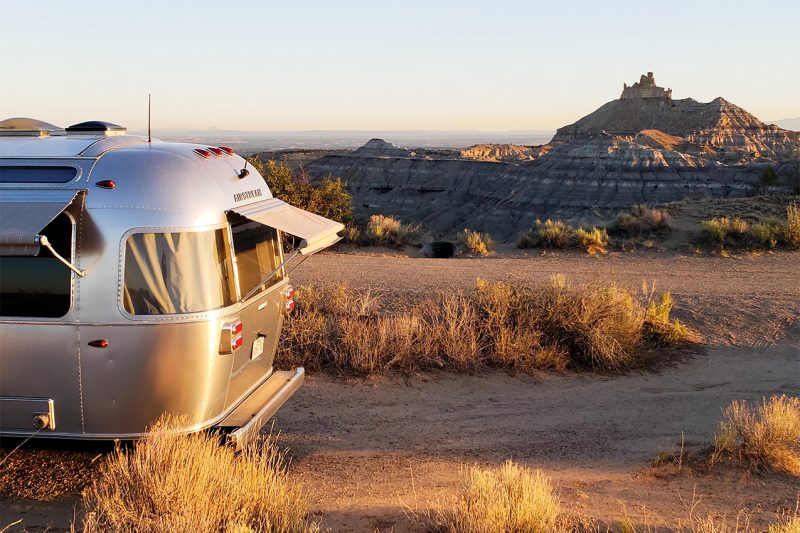 An Airstream glowing at sunset.
