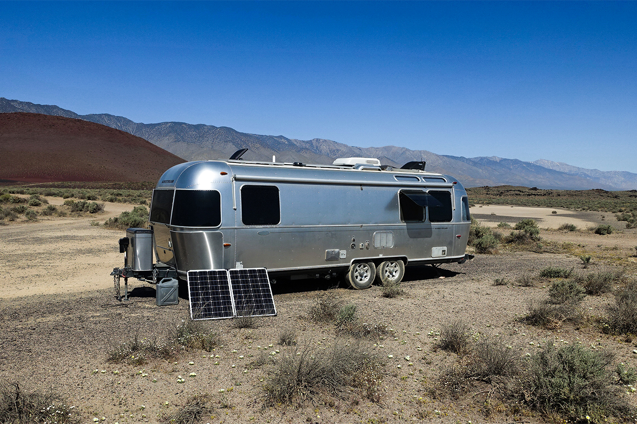 Airstream with solar panels in the desert.