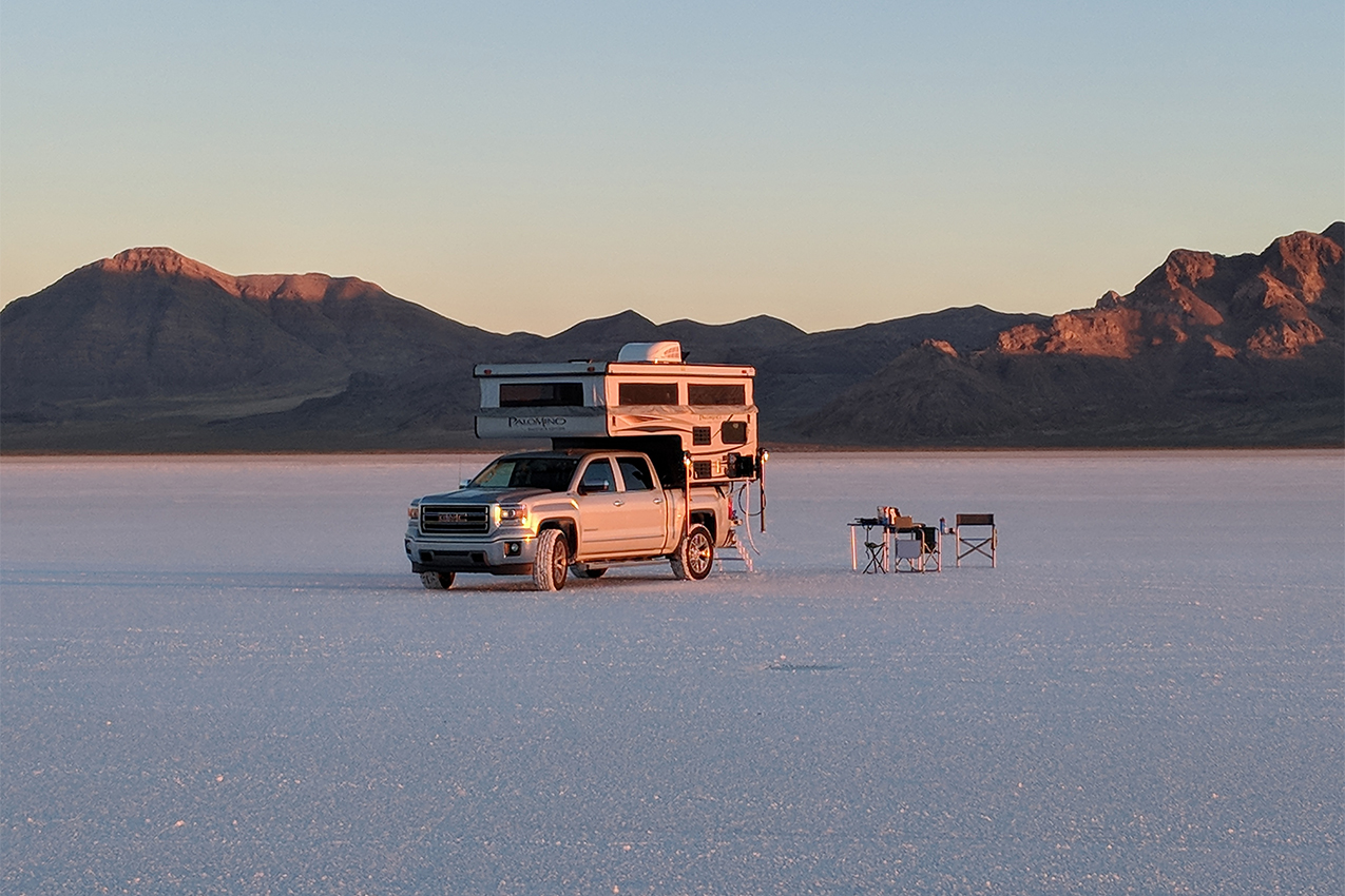 Truck camper parked in a salt flat.