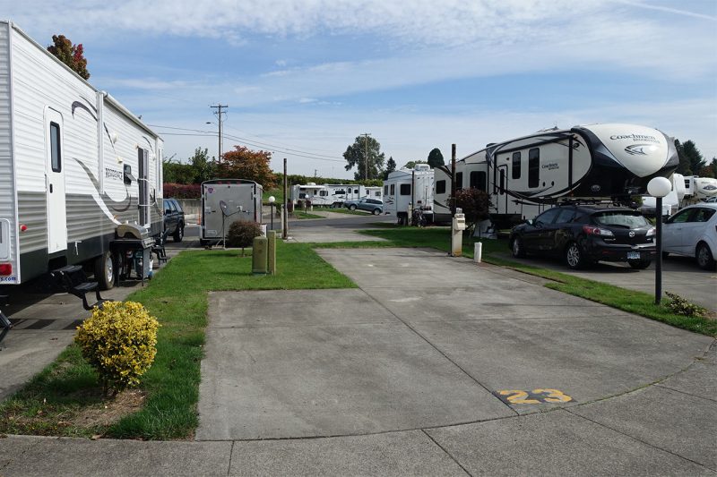 An empty RV spot in a crowded RV park.