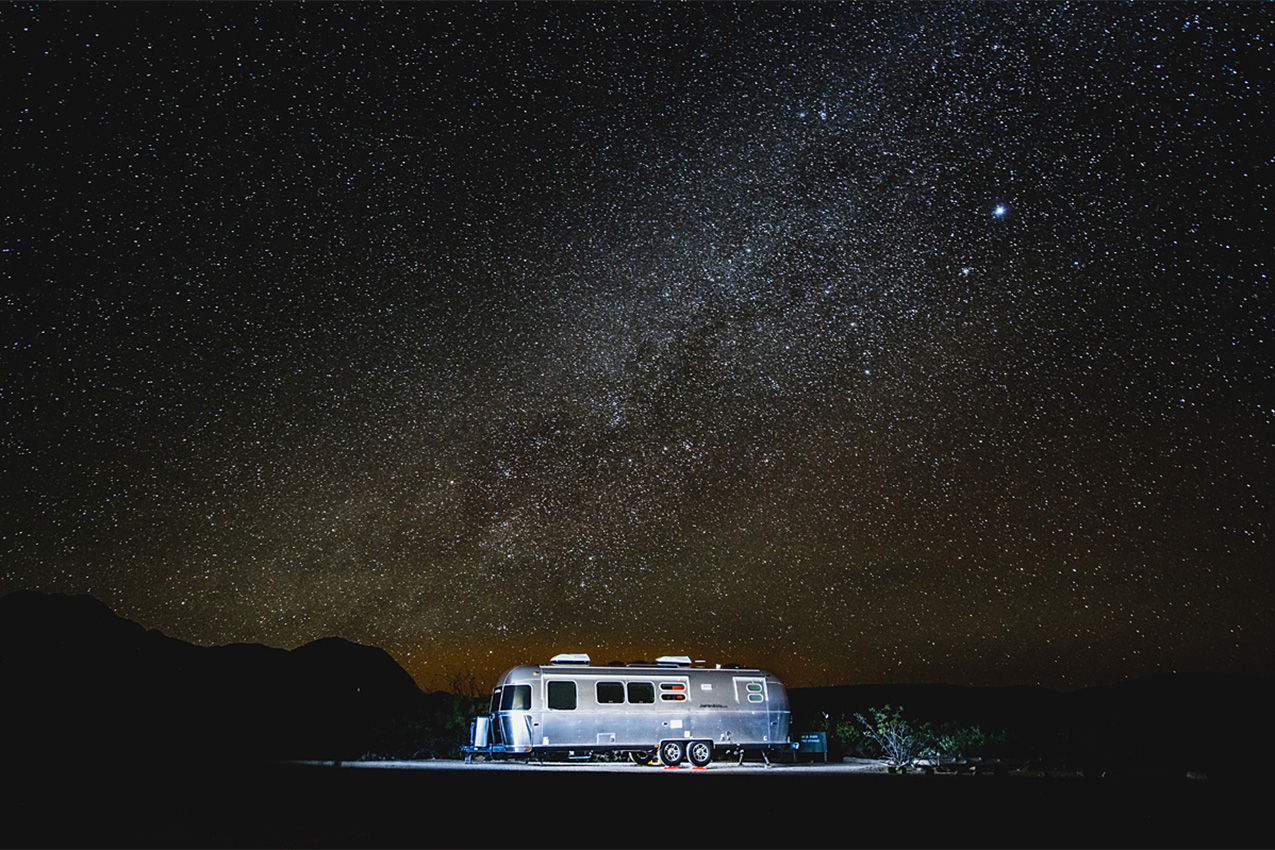 Night photo of Airstream under the stars.