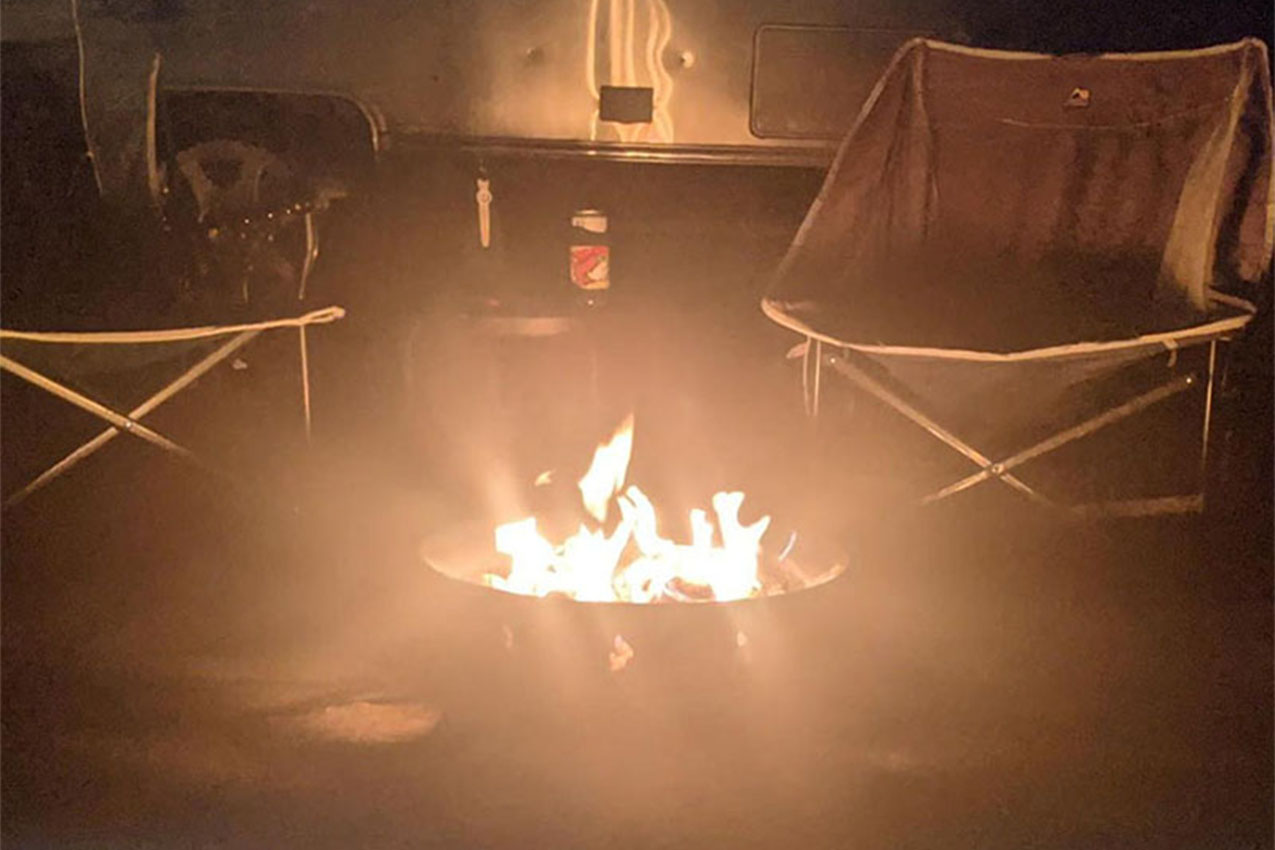 Propane camp fire in front of an RV.