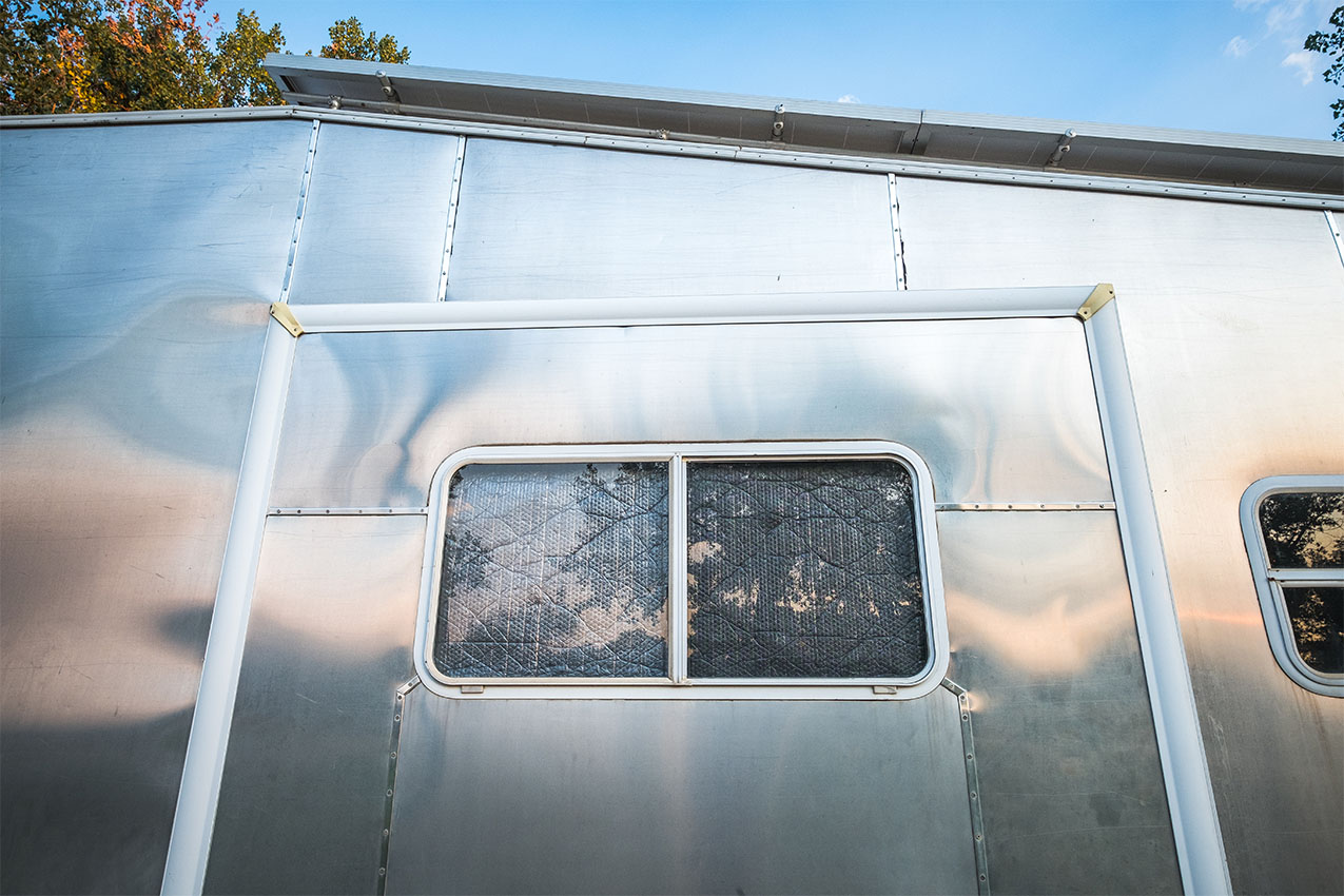 Silver RV with Reflectix in the window.