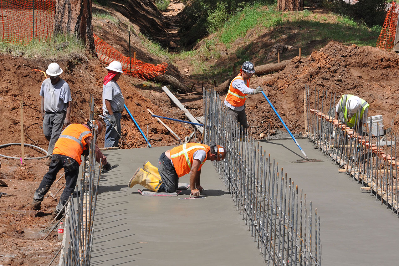 Construction crew paving concrete at staging area in Grand Canyon National Park.