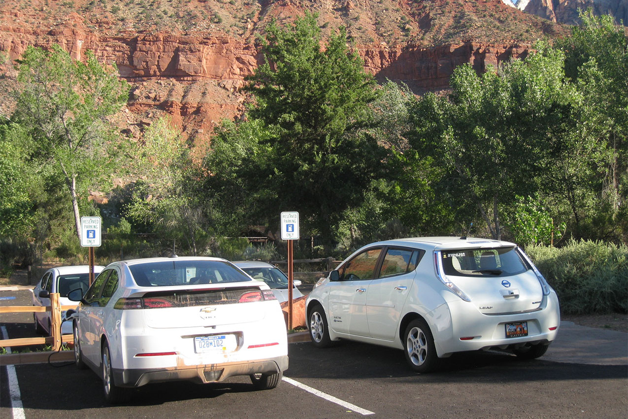 Two electric vehicles charging at Zion National Park.