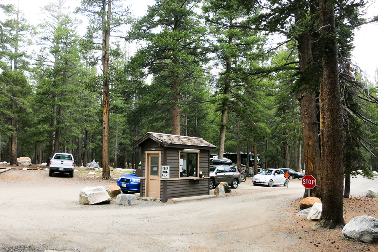 Entrance station with cars pulled up in a national park campground.