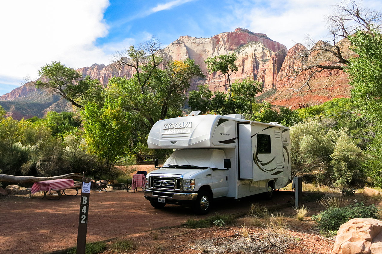 Class C surrounded by red cliffs in Zion National Park.