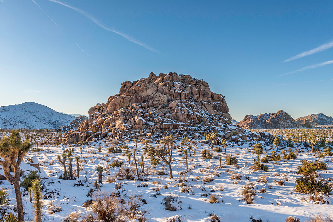 Snow covered round rocks in Joshua Tree National Park.