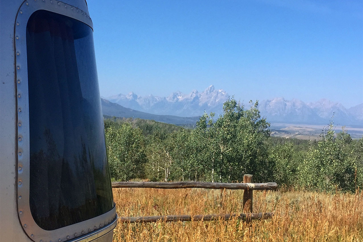 Airstream window looking out at the Teton montains.