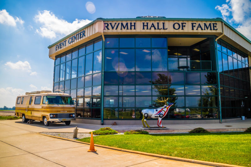 Exterior of RV Hall of Fame with a camper sitting in front.