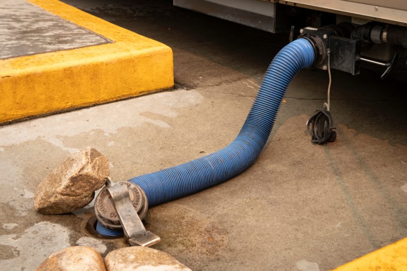 RV sewer hose connected to a dump station