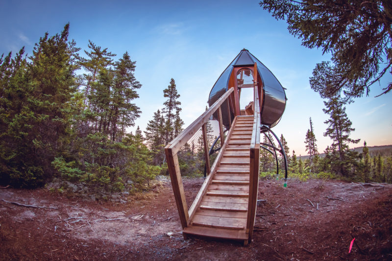 Pod sleeping accommodations with staircase in remote area
