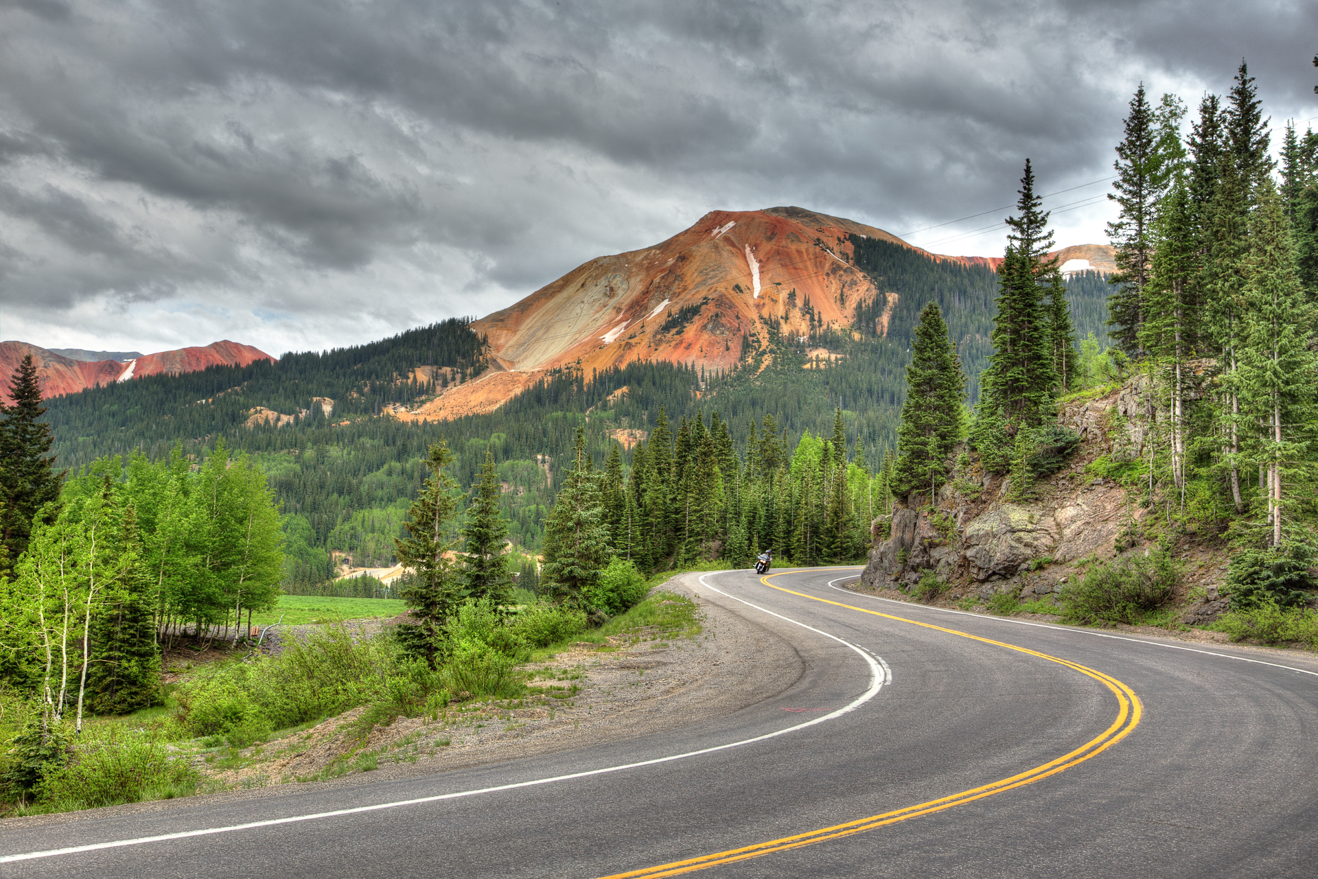 A motorcyclist travels along the Million Dollar Highway in southwest Colorado through the La Plata Mountains (Rocky Mountains)