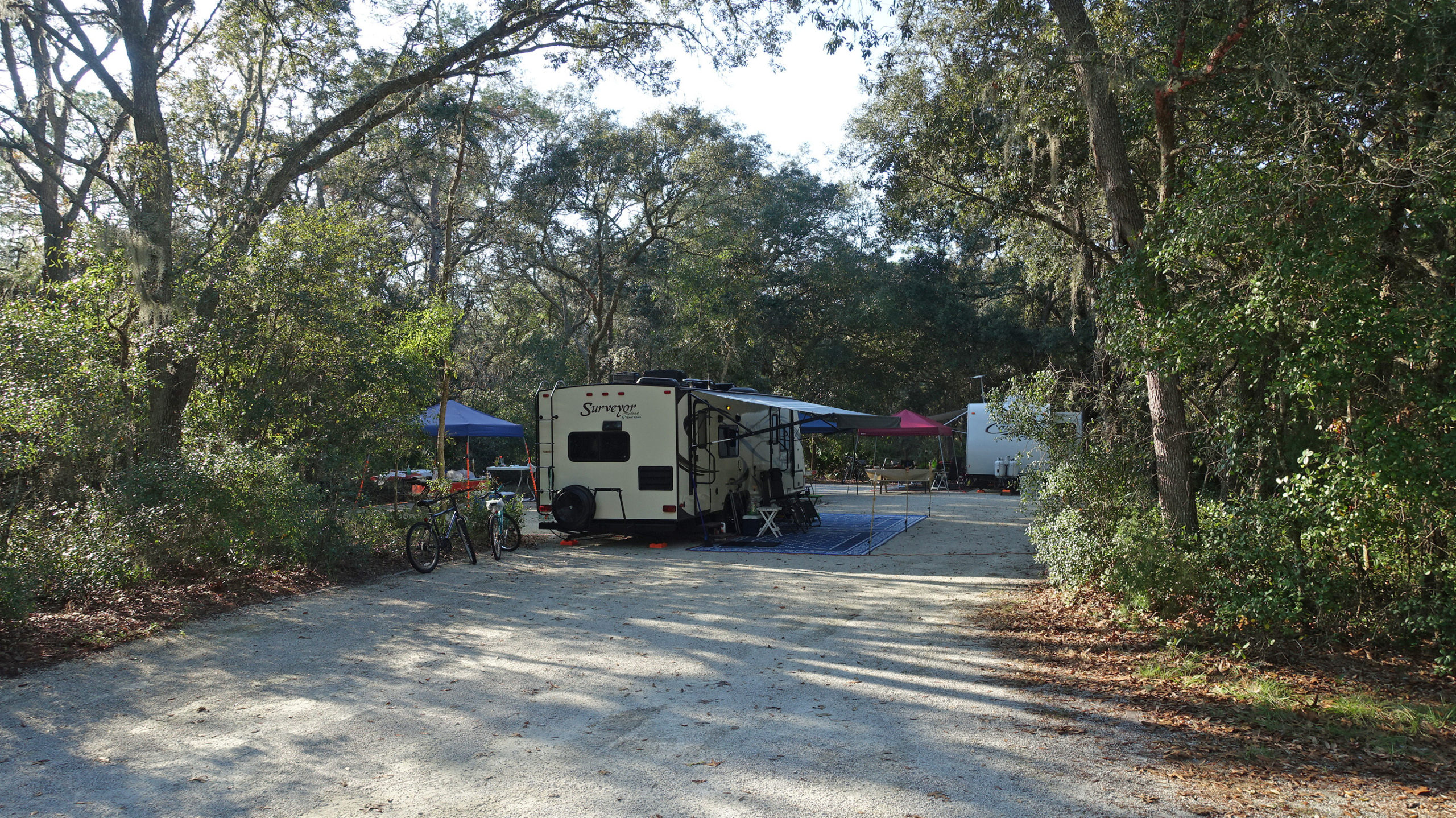 RV with awning extended parked at a state park campground