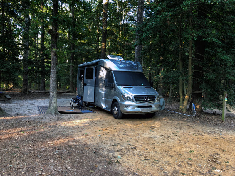 Camper parked in a wooded area at Killens Pond State Park in Delaware.