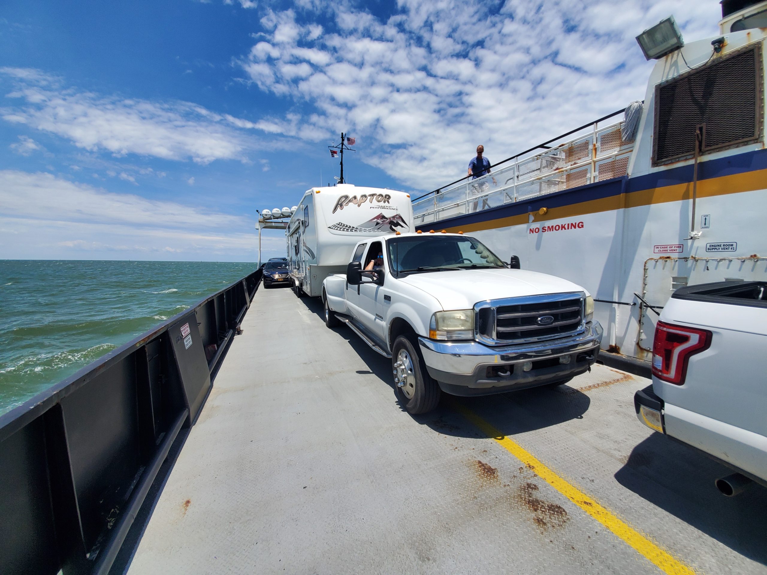 Ferry with an RV and truck on it heading to the Oracoke Campground