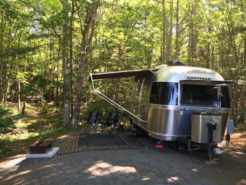 Wooded campsite with an Airstream travel trailer near Acadia National Park