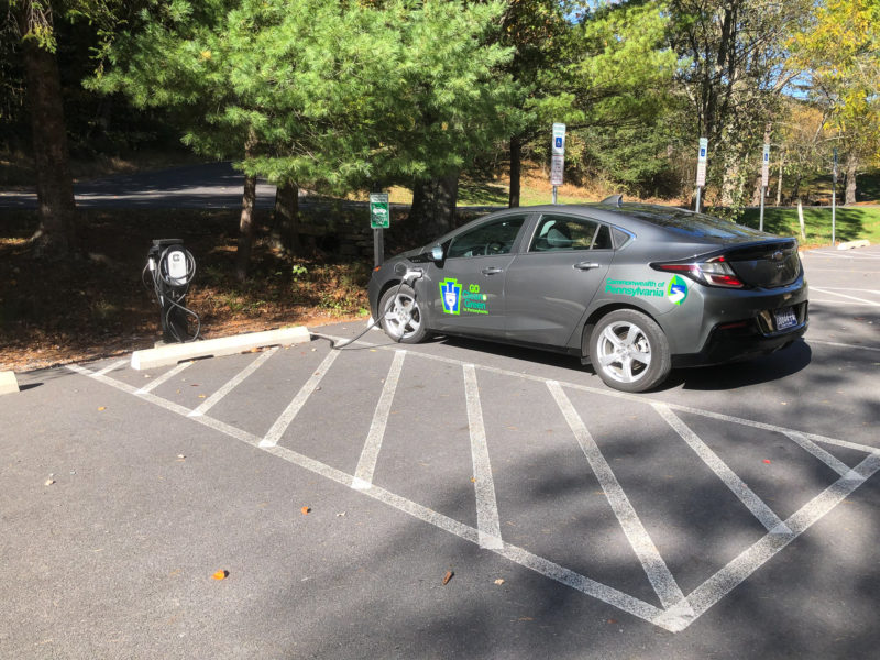 Electric vehicle charging in parking lot at state park