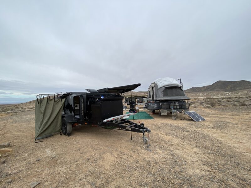 An overlanding RV set up in a remote campsite 