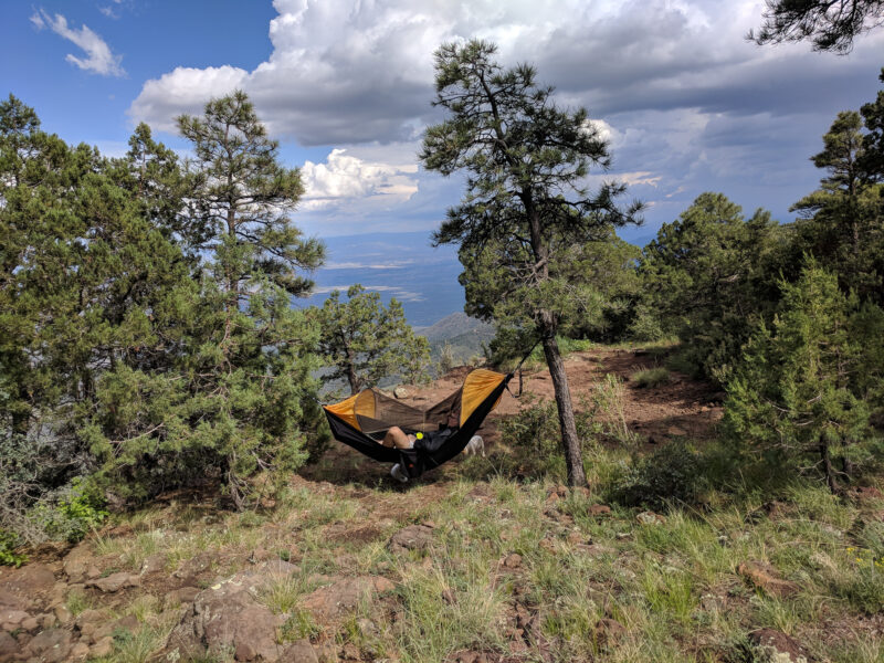 Person hanging in hammock at camping in dispersed camping area