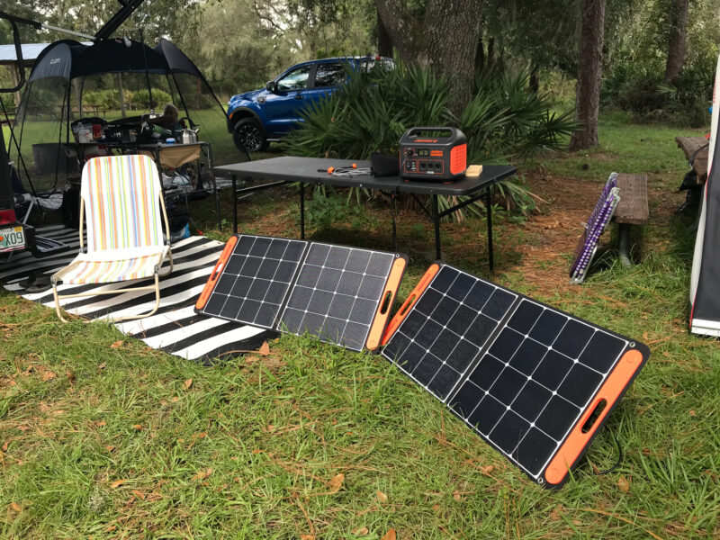 Solar panels set up at a campsite with power bank