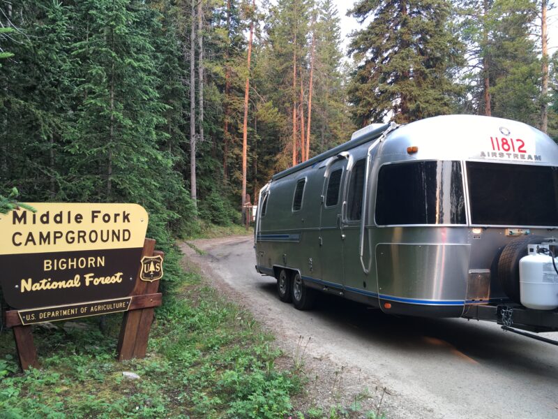 Trailer in front of national forest sign