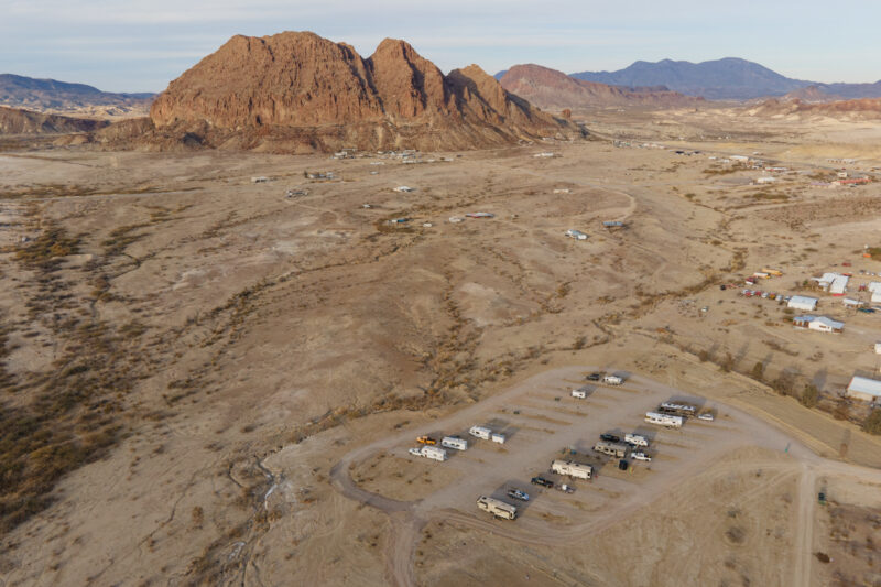 An aerial view of an RV campground in a remote, desert area of Texas