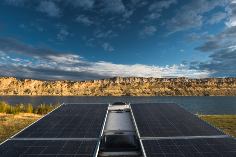 Solar panels on roof of RV overlooking scenic destination