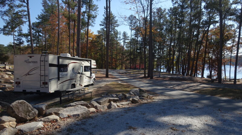 Motorhome parked at campsite overlooking a lake