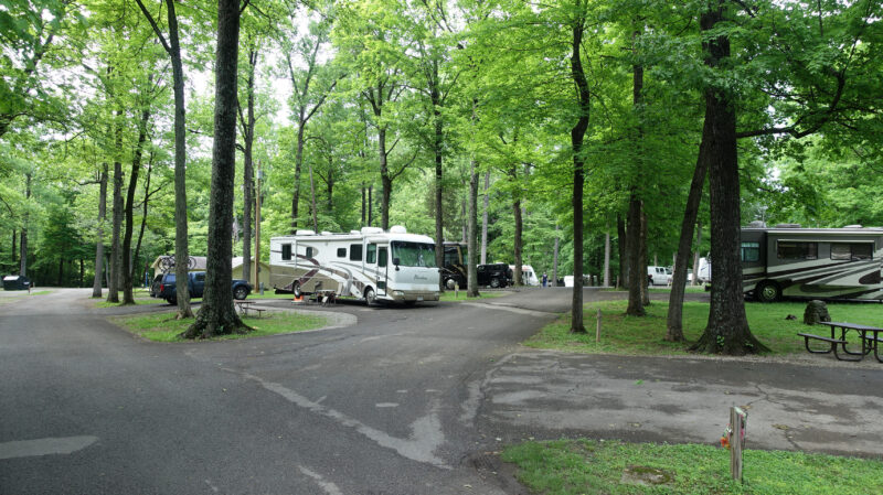 a campground with rvs parked under the trees
